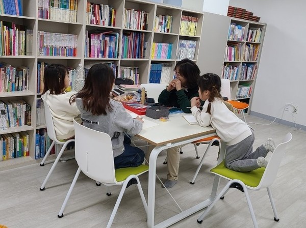 증평군에서 운영중인 '행복돌봄나눔터'중 하나인 초롱이작은 도서관에서 아이들이 책을 읽으며 토론을 하고 있다.
